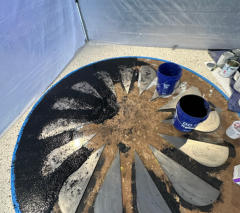 Terrazzo being installed around metal petals to make logo.